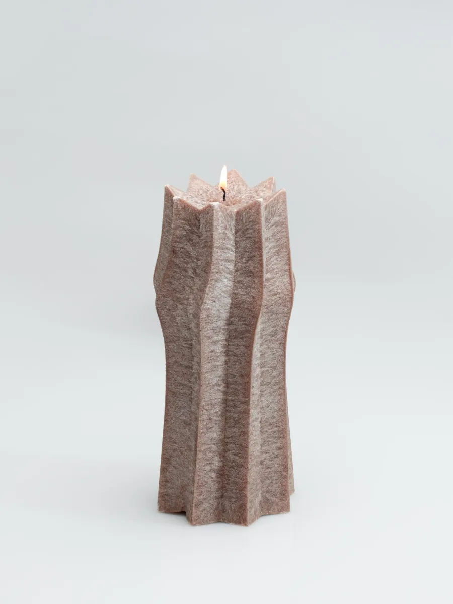 Powder-coloured faceted “King Sigismund Augustus” candle on a light background