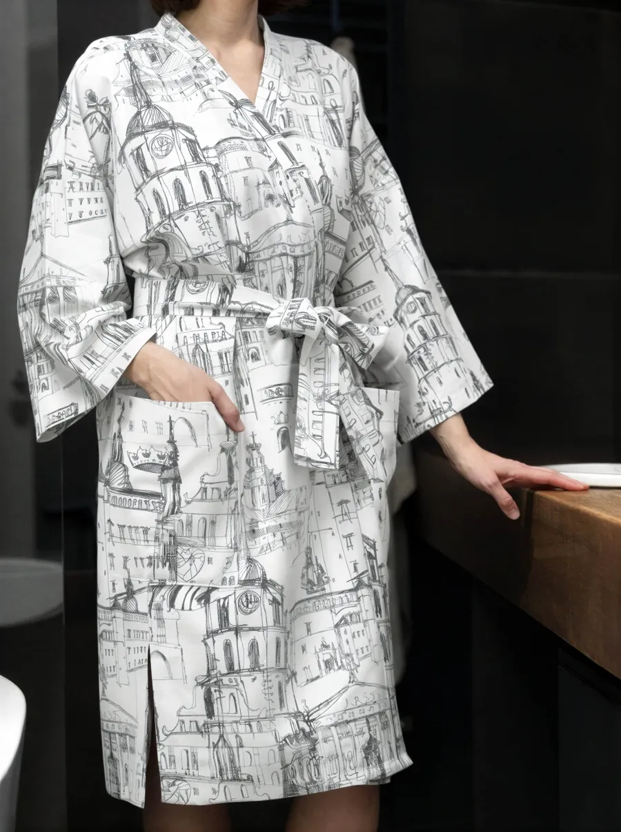 Model in a white “Royal Vilnius Love Story” kimono robe in a bathroom by the worktop, front