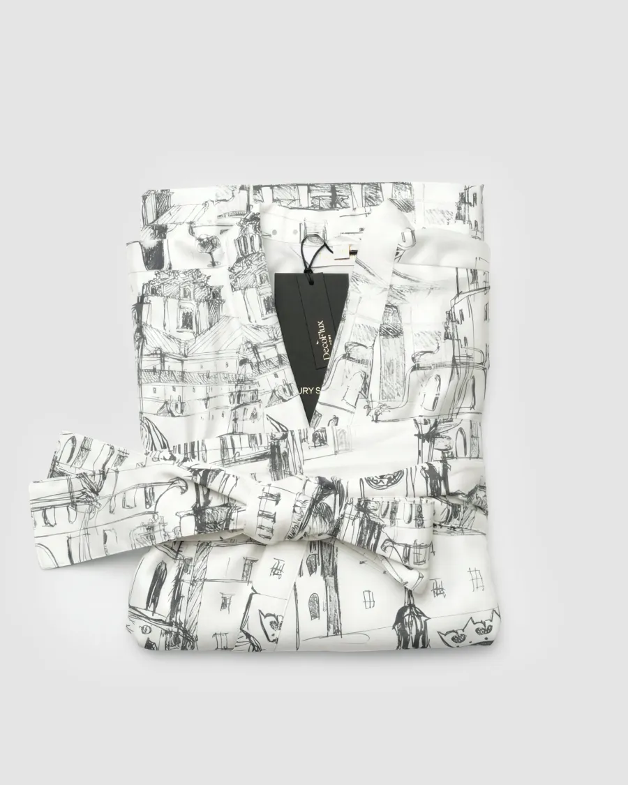 A folded white “Royal Vilnius Love Story” satin kimono robe with a label