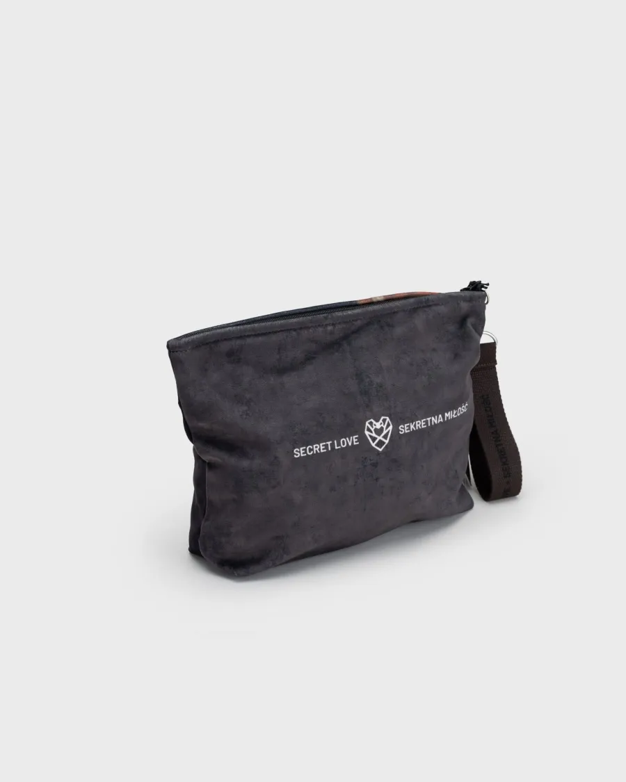 Back of a dark grey “Augustus” cosmetic bag with the words “Secret Love” and a heart logo