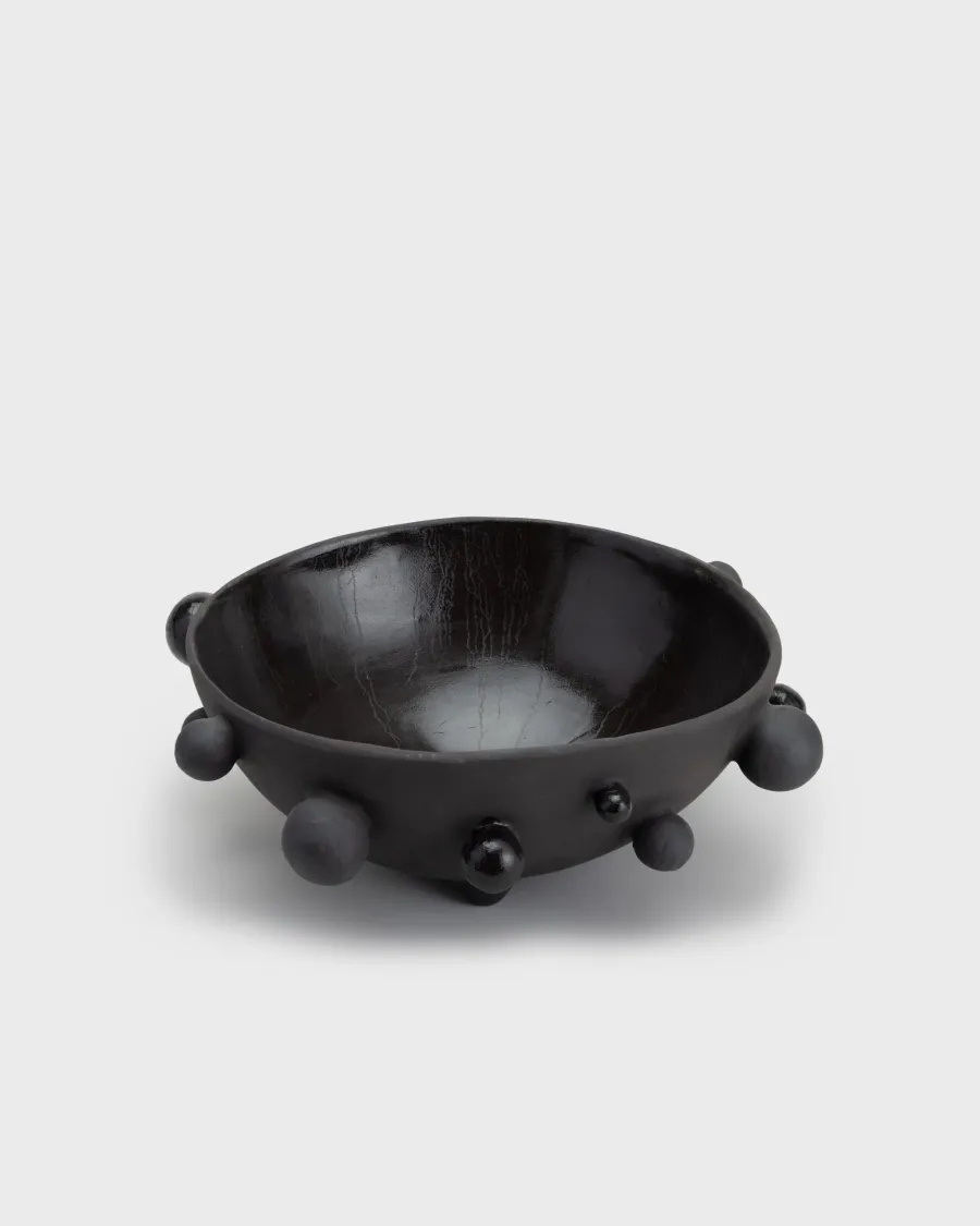 Large matte black “The Queen's Pearl Bowl” with ball feet on a light background