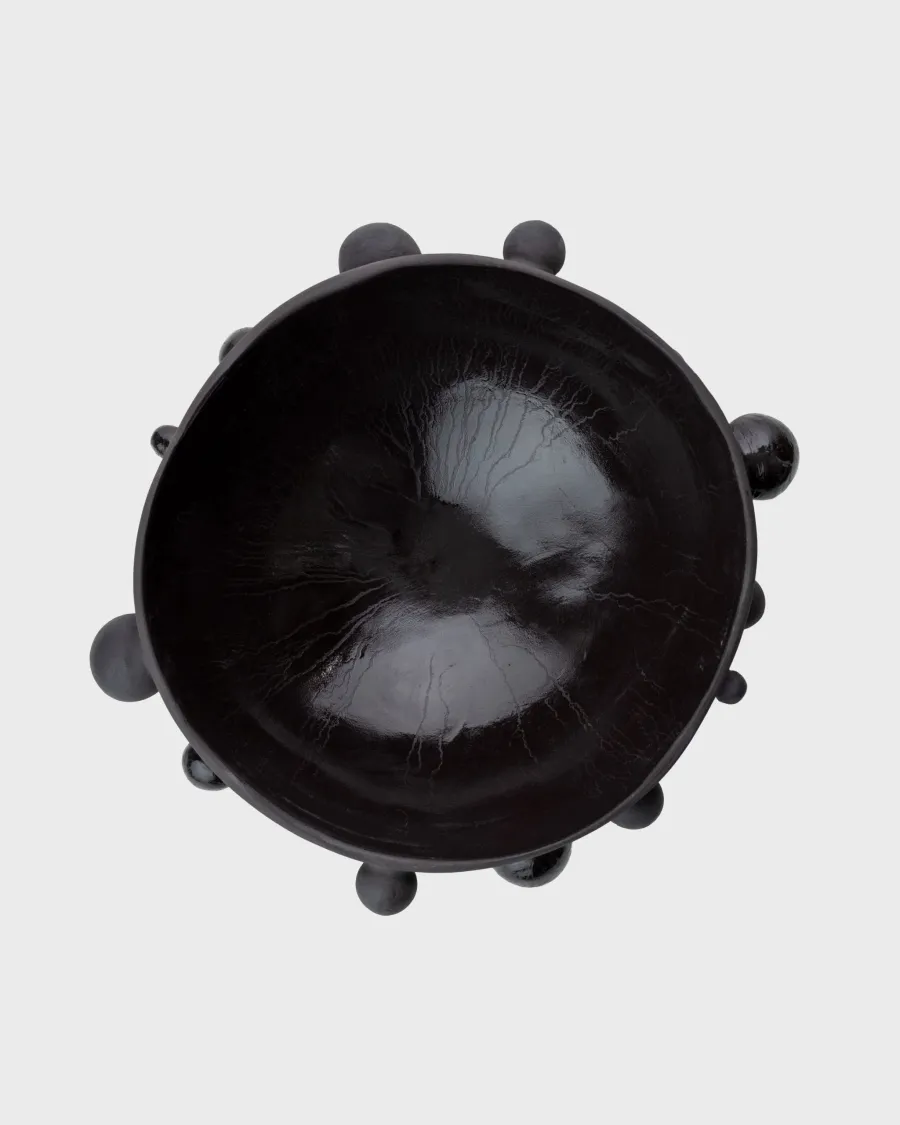 Large matte black “The Queen's Pearl Bowl” from above, glossy inside visible
