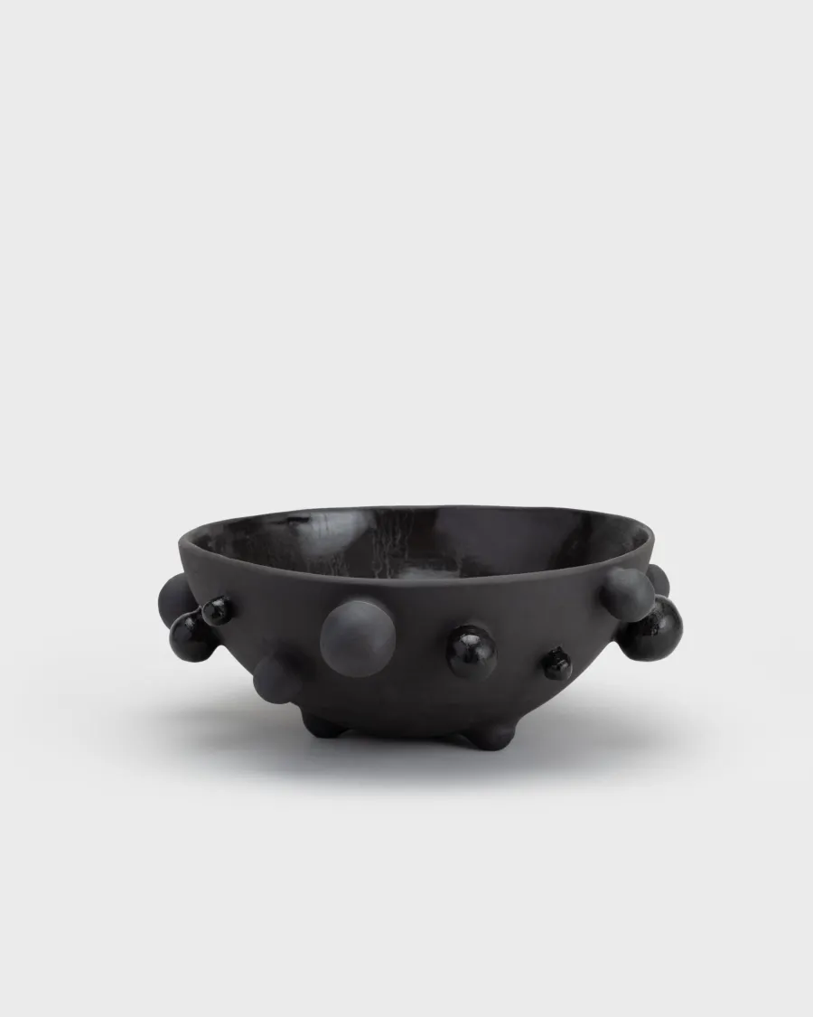 Large matte black “The Queen's Pearl Bowl” from the side, seen from a distance