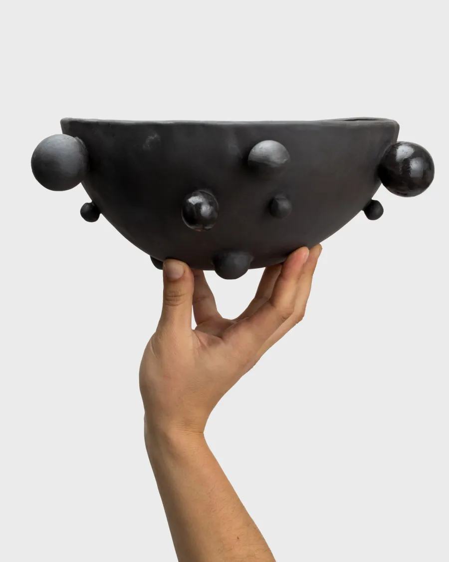 Medium matte black “The Queen's Pearl Bowl” held in one hand