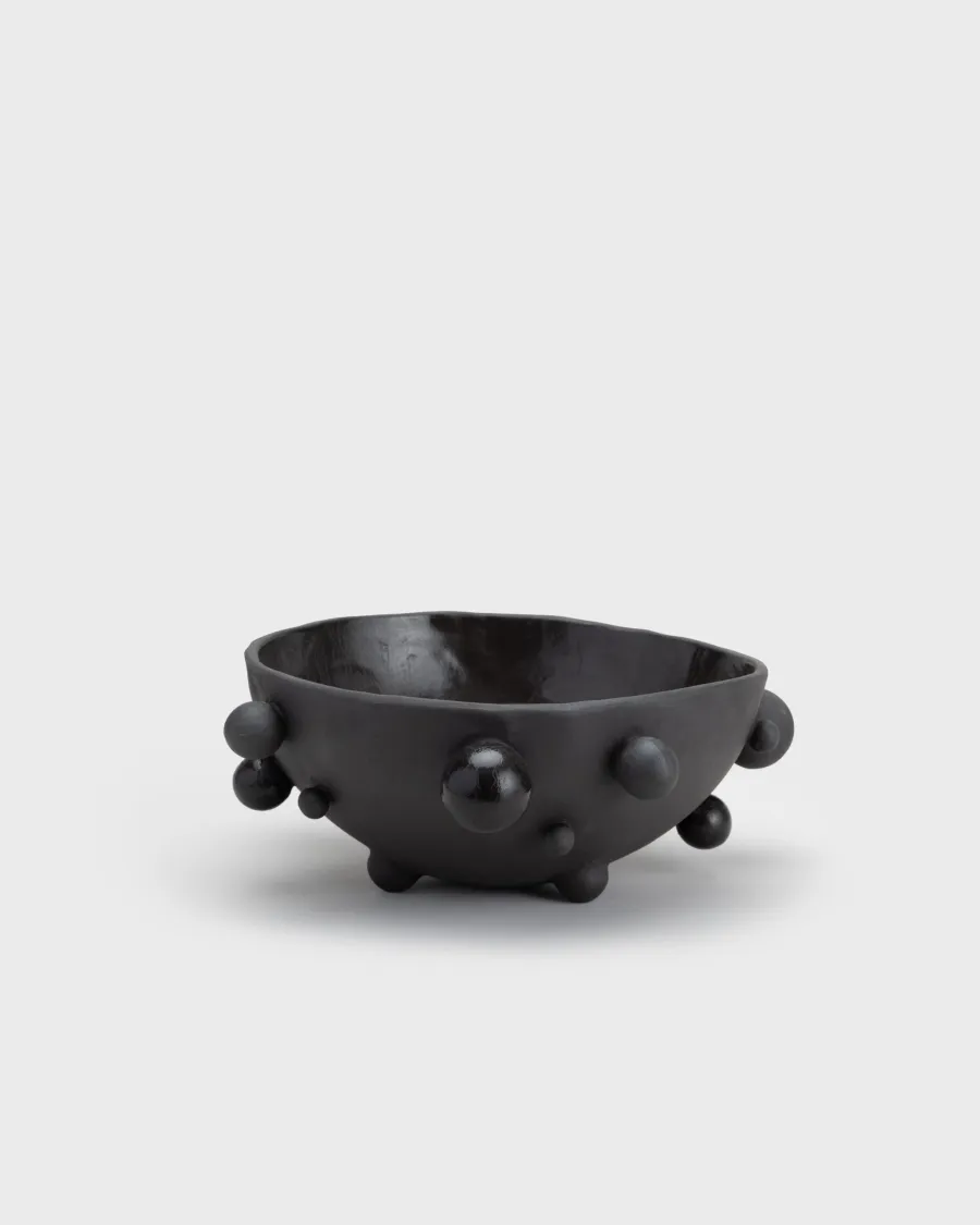 Medium matte black “The Queen's Pearl Bowl” from the side, distant view
