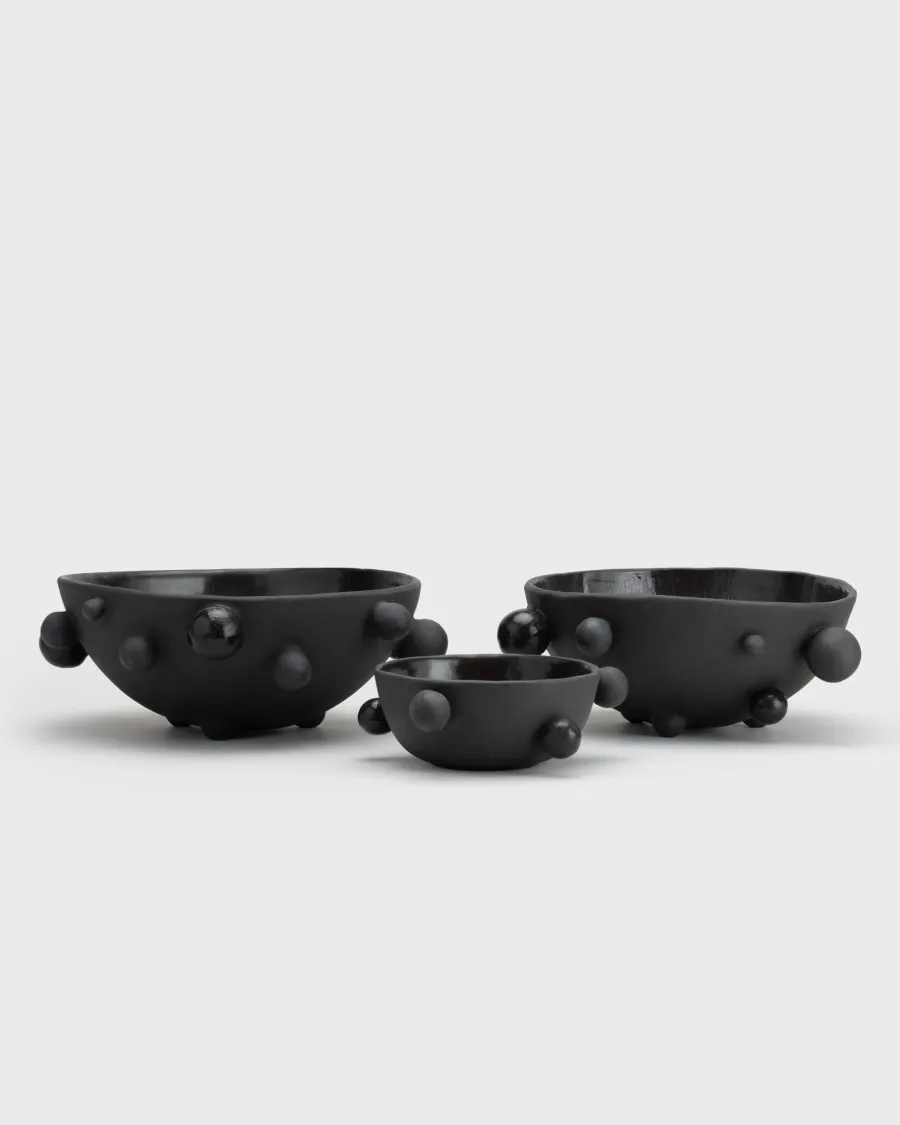 Three matte black “The Queen's Pearl Bowl” bowls in different sizes side by side, side view
