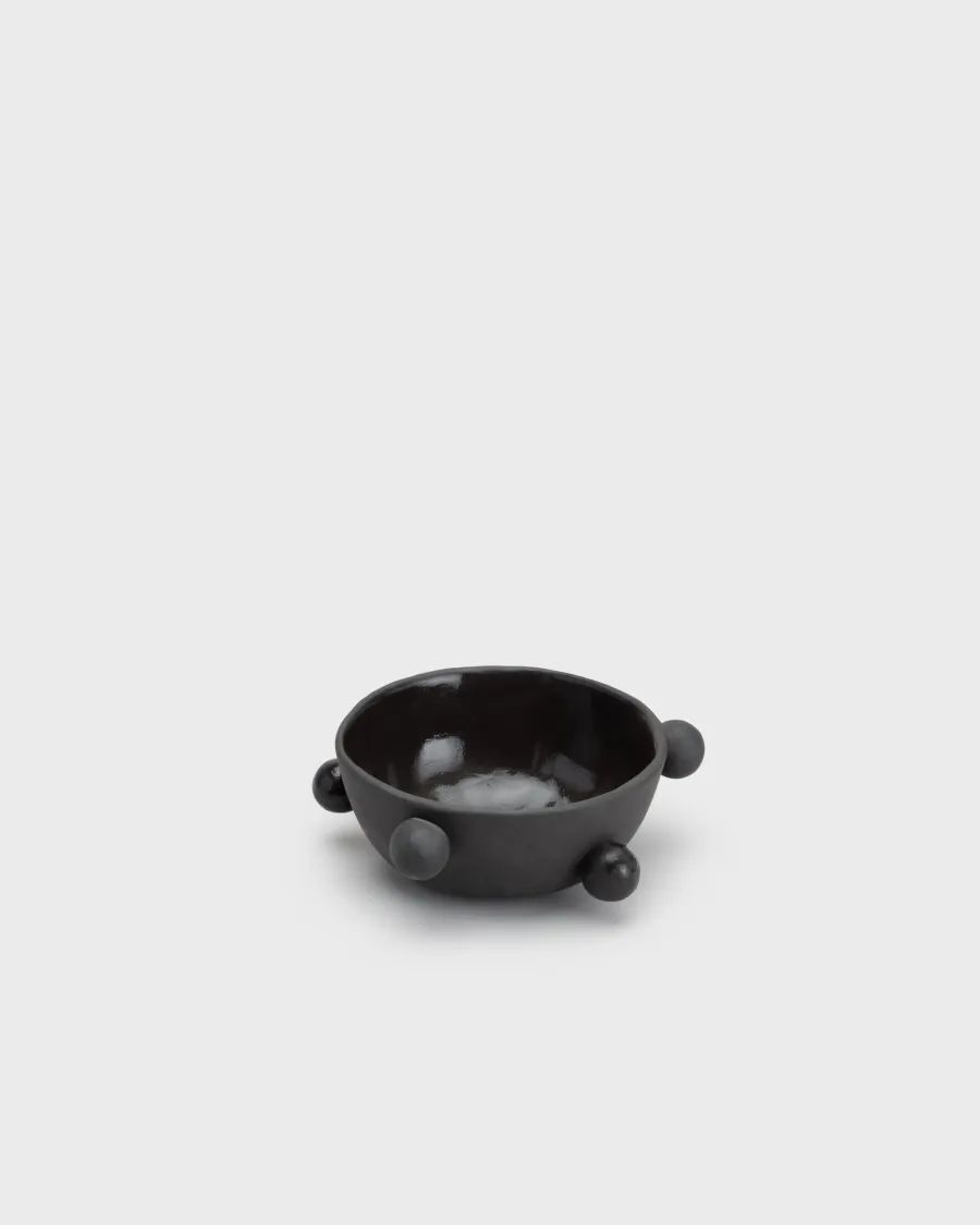 Small matte black “The Queen's Pearl Bowl” with balls on a light background