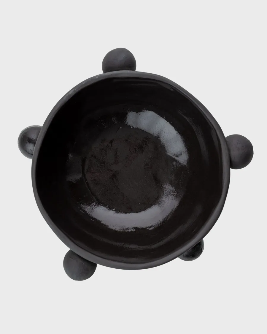 Small matte black “The Queen's Pearl Bowl” from above with four balls