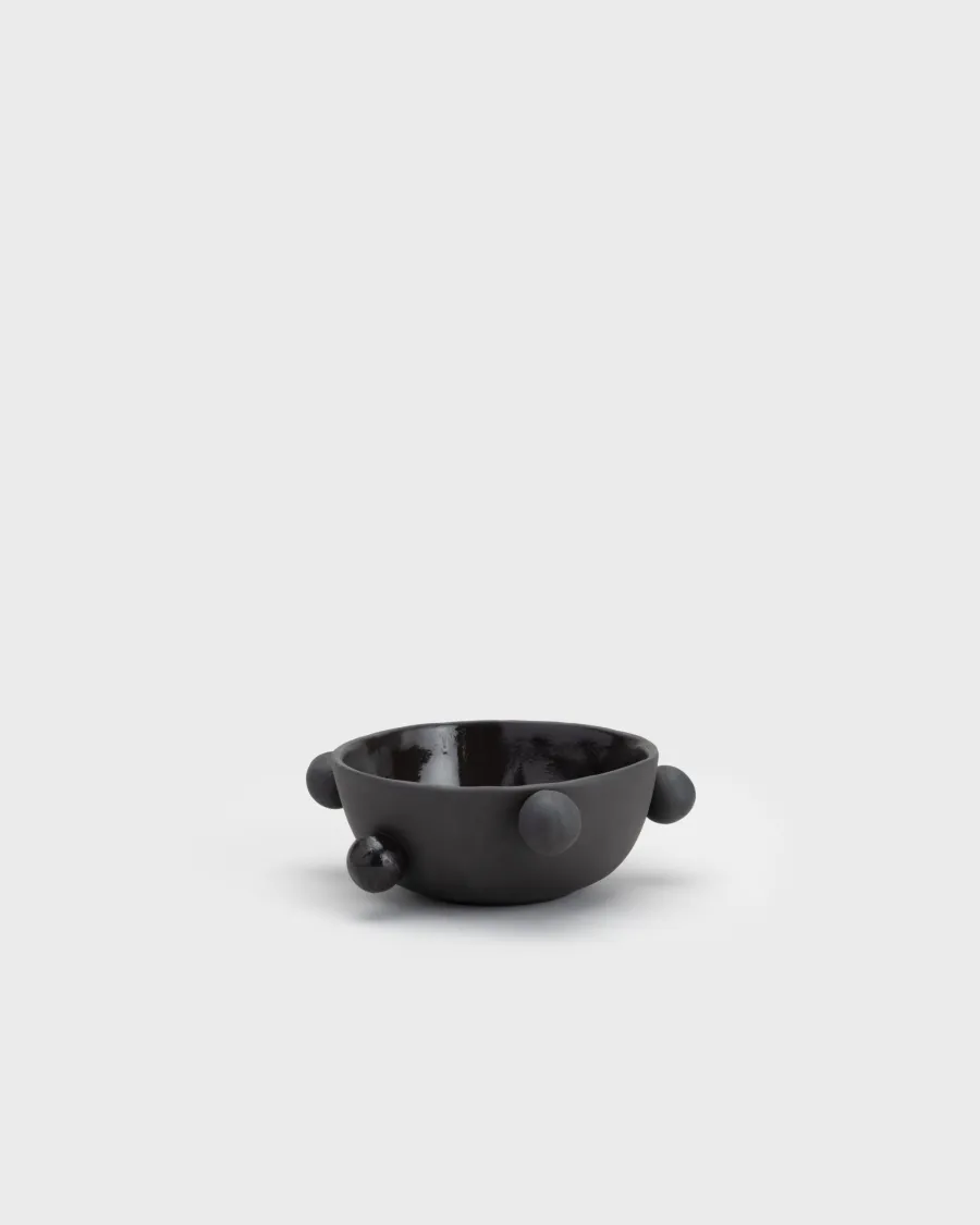 Small matte black “The Queen's Pearl Bowl” from the side, seen from a distance