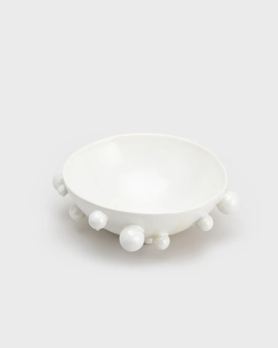Large pearl white “The Queen's Pearl Bowl” with ball feet on a light background