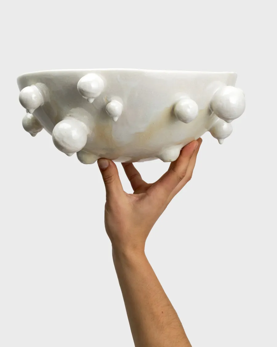 Large pearl white “The Queen's Pearl Bowl” held in one hand
