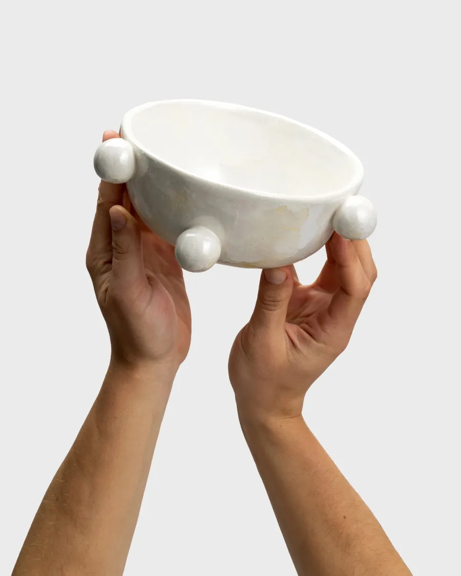 Small pearl white “The Queen's Pearl Bowl” in two raised hands