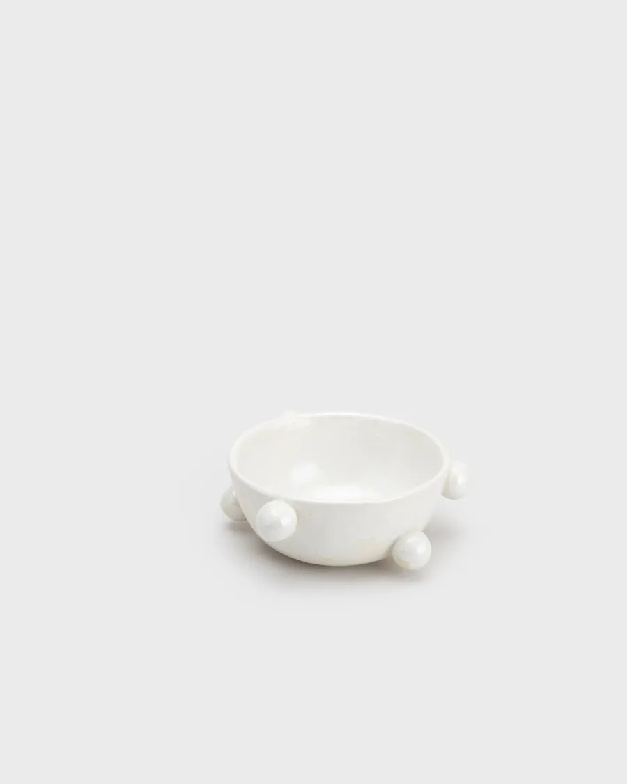 Small pearl white “The Queen's Pearl Bowl” with balls on a light background