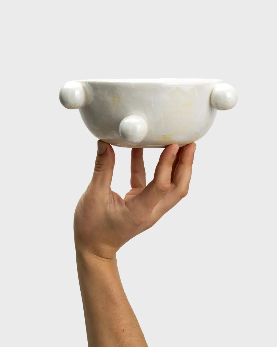 Small pearl white “The Queen's Pearl Bowl” on the palm of one hand