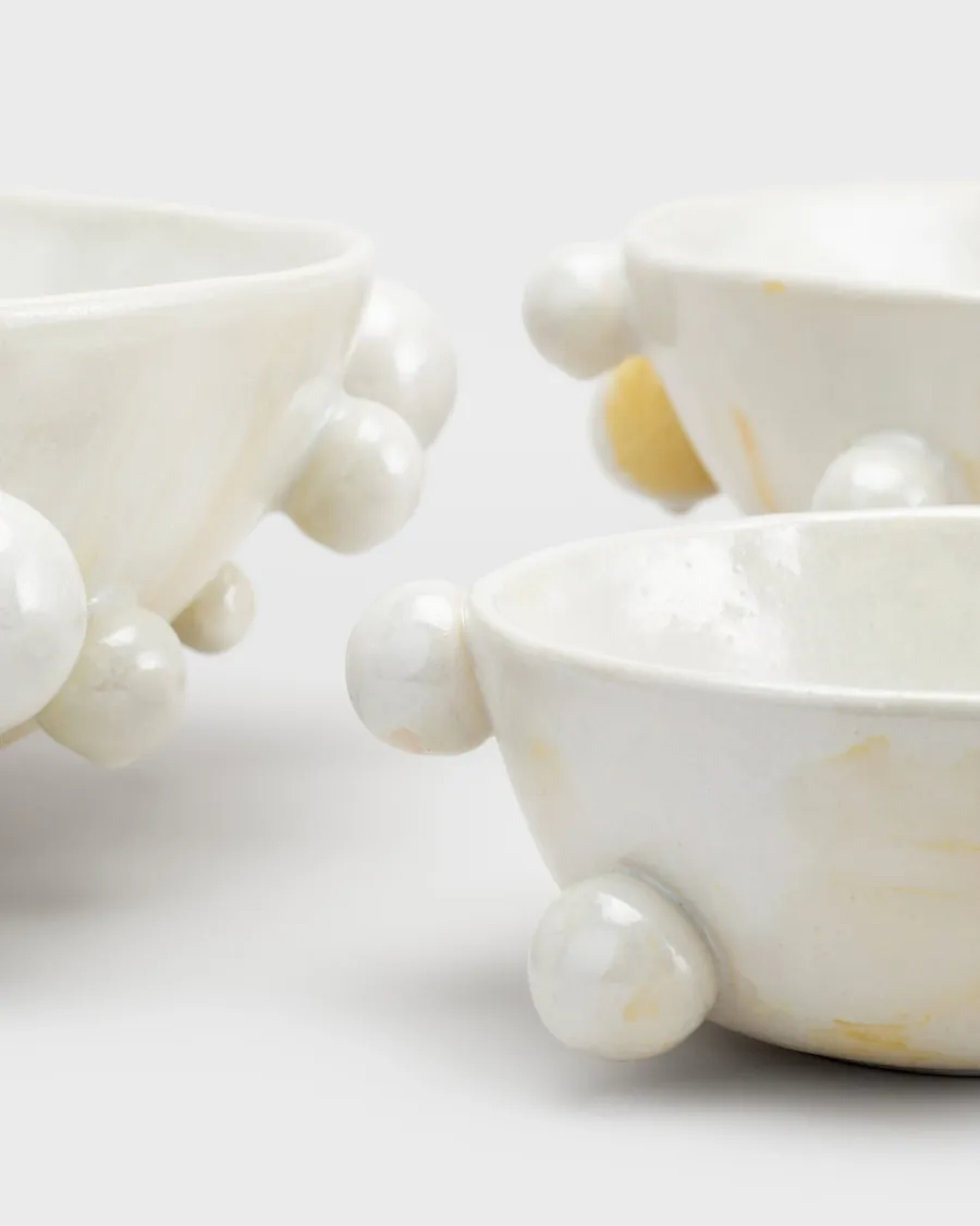 Close-up detail of the beads and glaze of pearl white “The Queen's Pearl Bowl” bowls