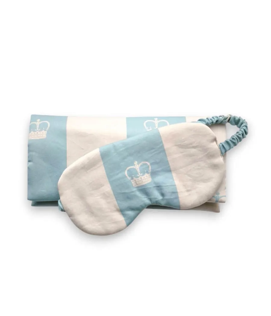 Light blue “Your Majesty” satin sleep mask on folded striped fabric