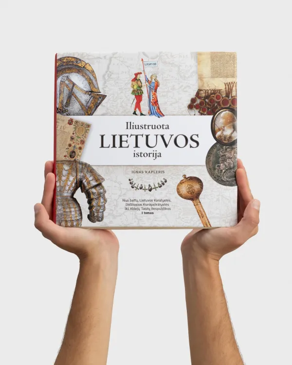 Rankos laiko knygą „Iliustruota Lietuvos istorija. I tomas“ su šarvų ir ginklų viršeliu
