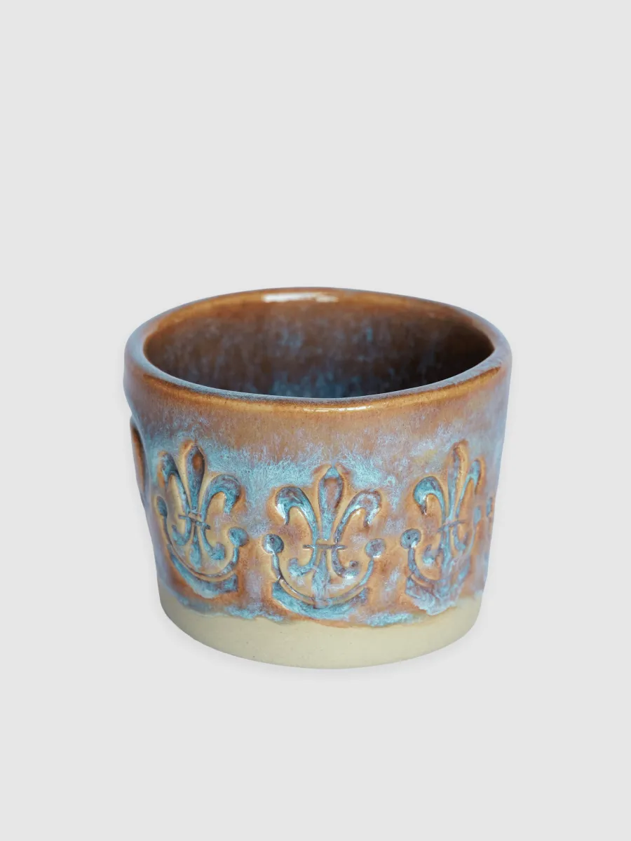 Bluish-brown glazed “Throne” espresso cup, side with an ornamental relief