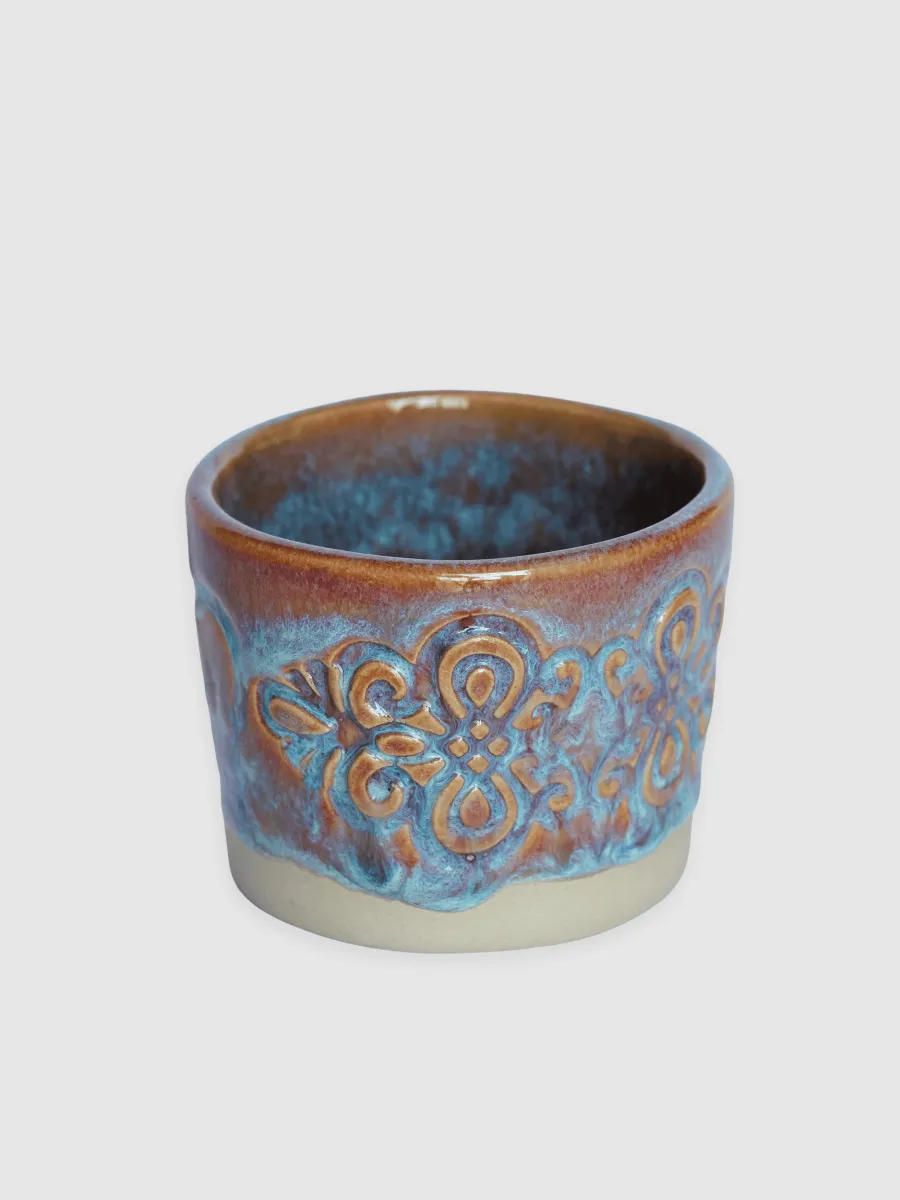 Blue-glazed “Throne” espresso cup with an ornament relief and a brown rim