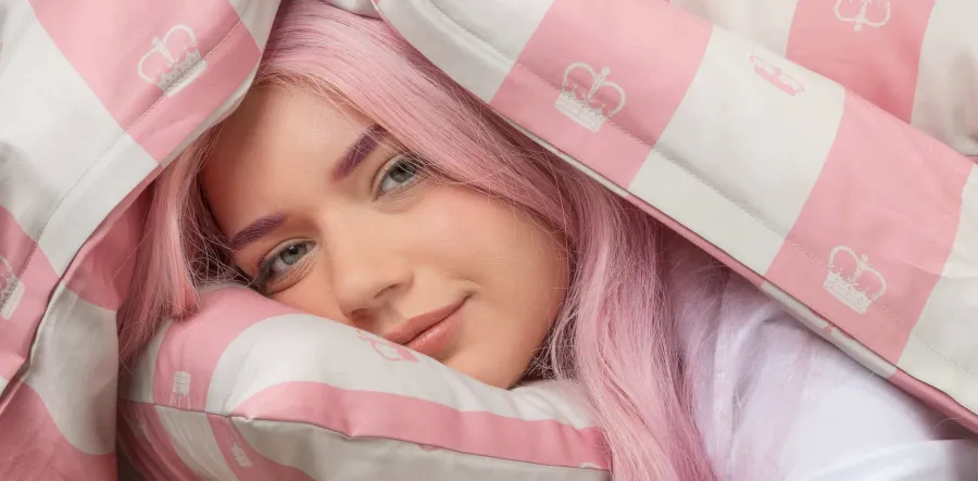 “Your Majesty” collection banner: a girl with pink hair under a pink striped duvet