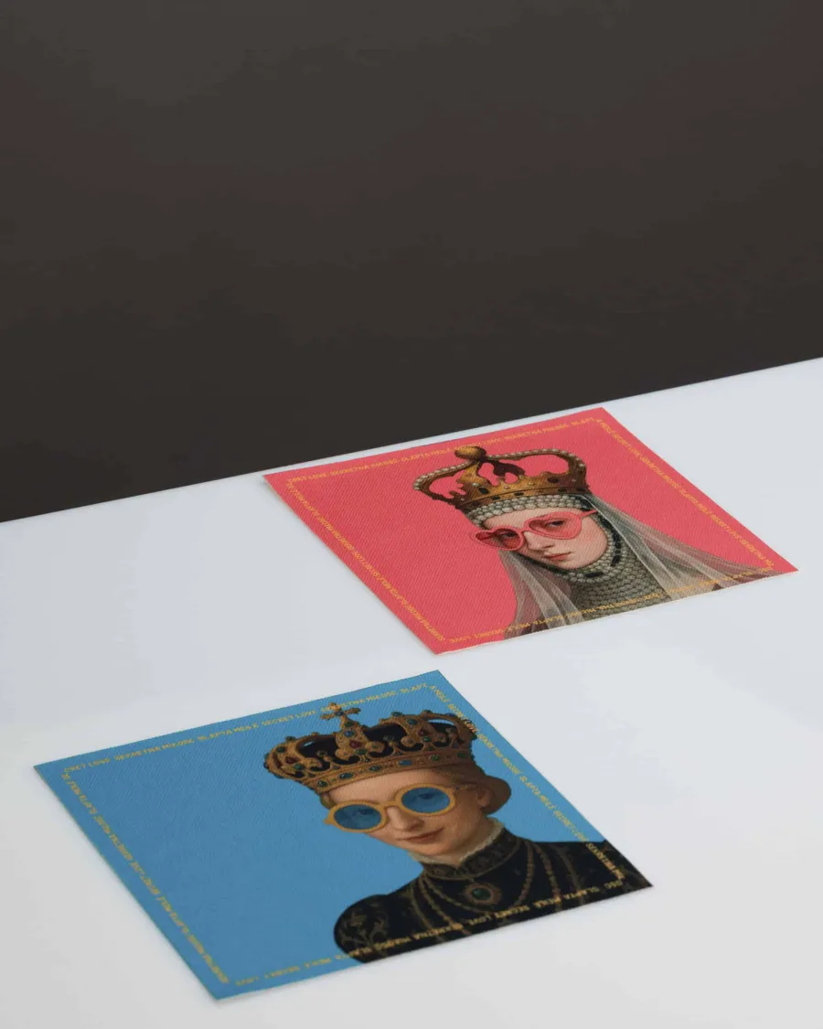 Two postcards with portraits of queens wearing crowns and glasses on pink and blue backgrounds